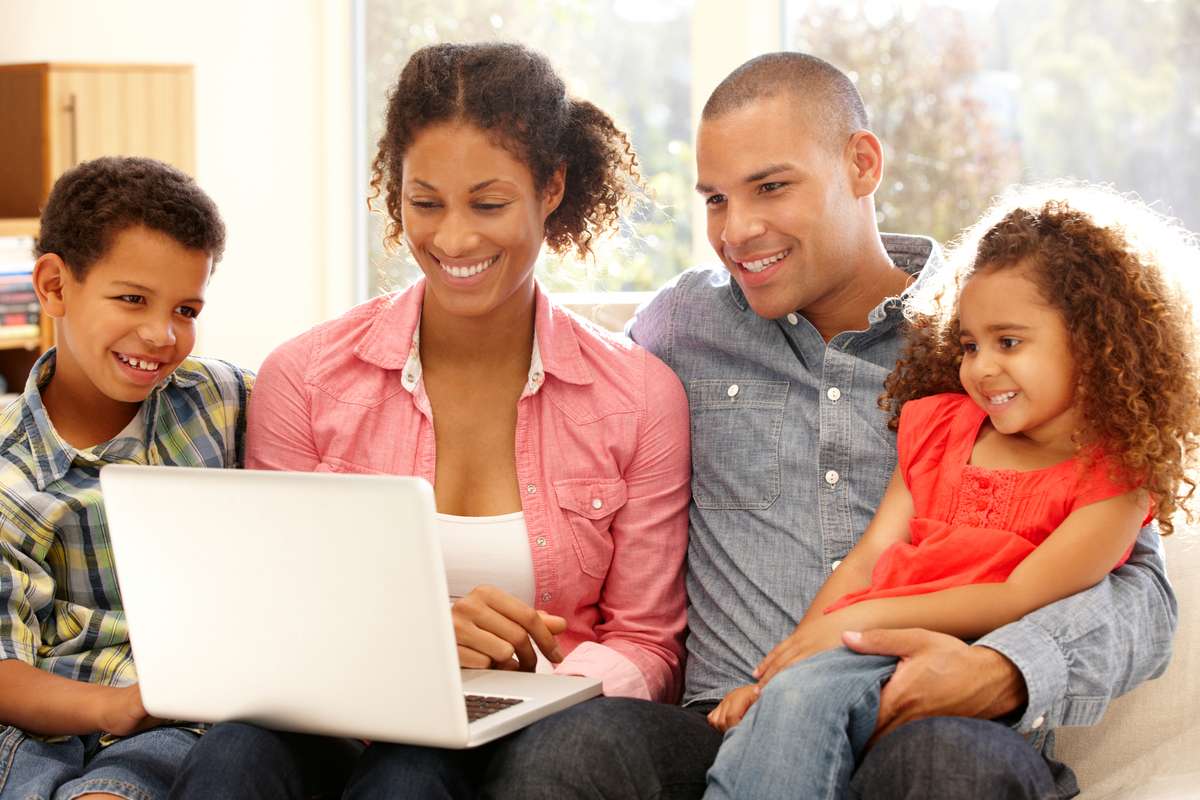 Family using laptop at home (R) (S)