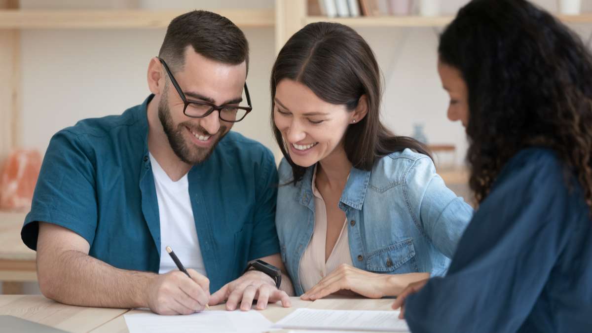 Happy family couple signing contract with agent (R) (S)