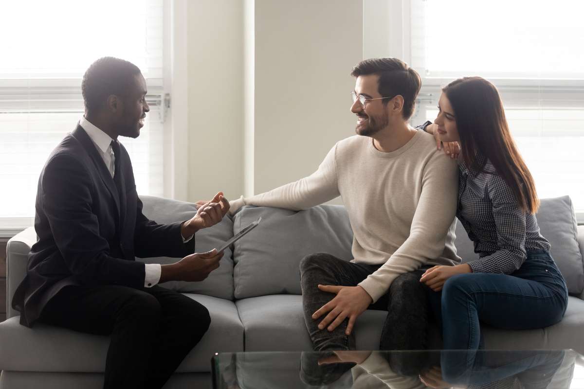 Happy young family couple listening to financial expert offer (R) (S)