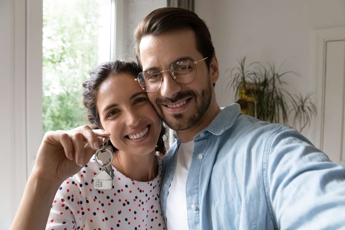 Head shot portrait wife and husband taking selfie, showing keys (R) (S)