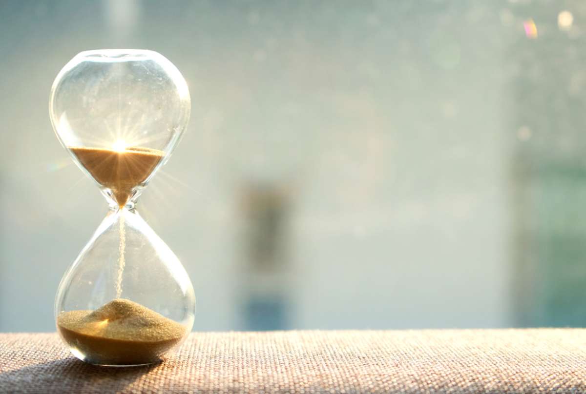 Hourglass with sun light background