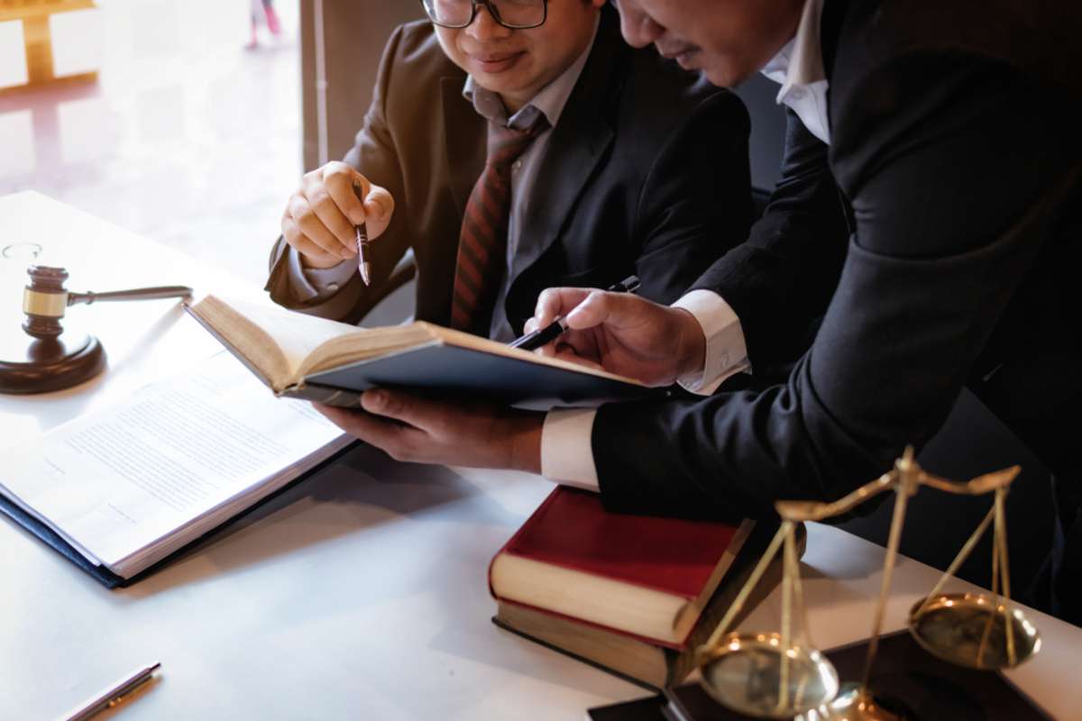 Lawyers having team meeting with law documents and negotiating contact in office