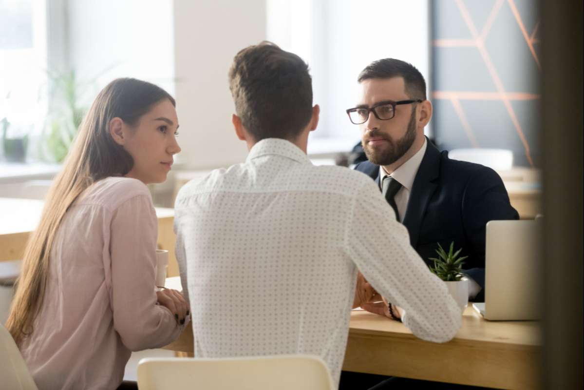 broker or realtor listening to millennial couple arguments or ideas (R) (S)