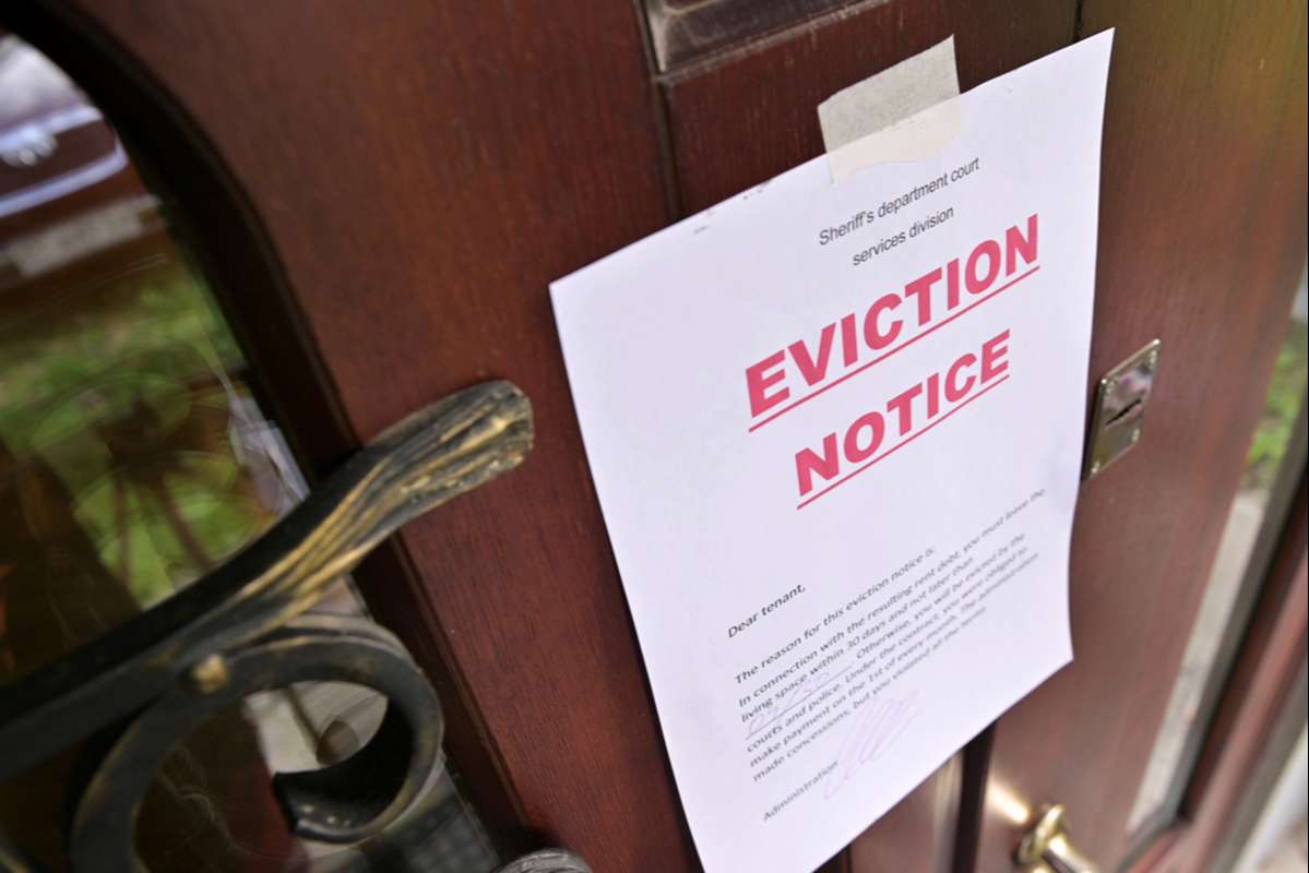 notice of eviction of tenants hangs on the door (R) (S)