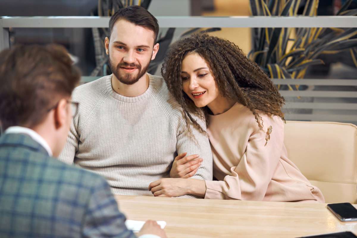 young man and woman talking with manager